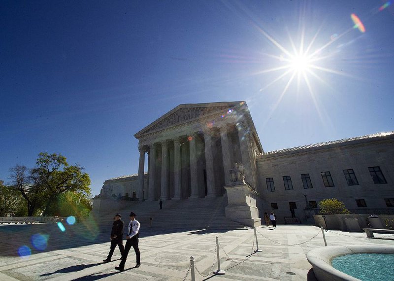 Supreme Court police officers patrol the plaza in front of the Supreme Court building in Washington on Tuesday, April 28, 2015, before the start of arguments on laws against gay marriage. 