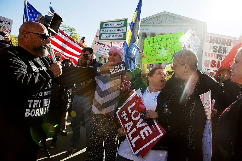 Ruben Israel (left) of the Los Angeles chapter of the Bible Believers group argues Tuesday with Nancy Brodzki (center, holding sign), a Florida-based attorney, outside the Supreme Court.