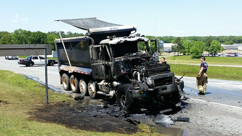 A dump truck hauling bauxite caught fire Wednesday, April 29, 2015, off Interstate 30 in Little Rock. No one was injured in the fire.