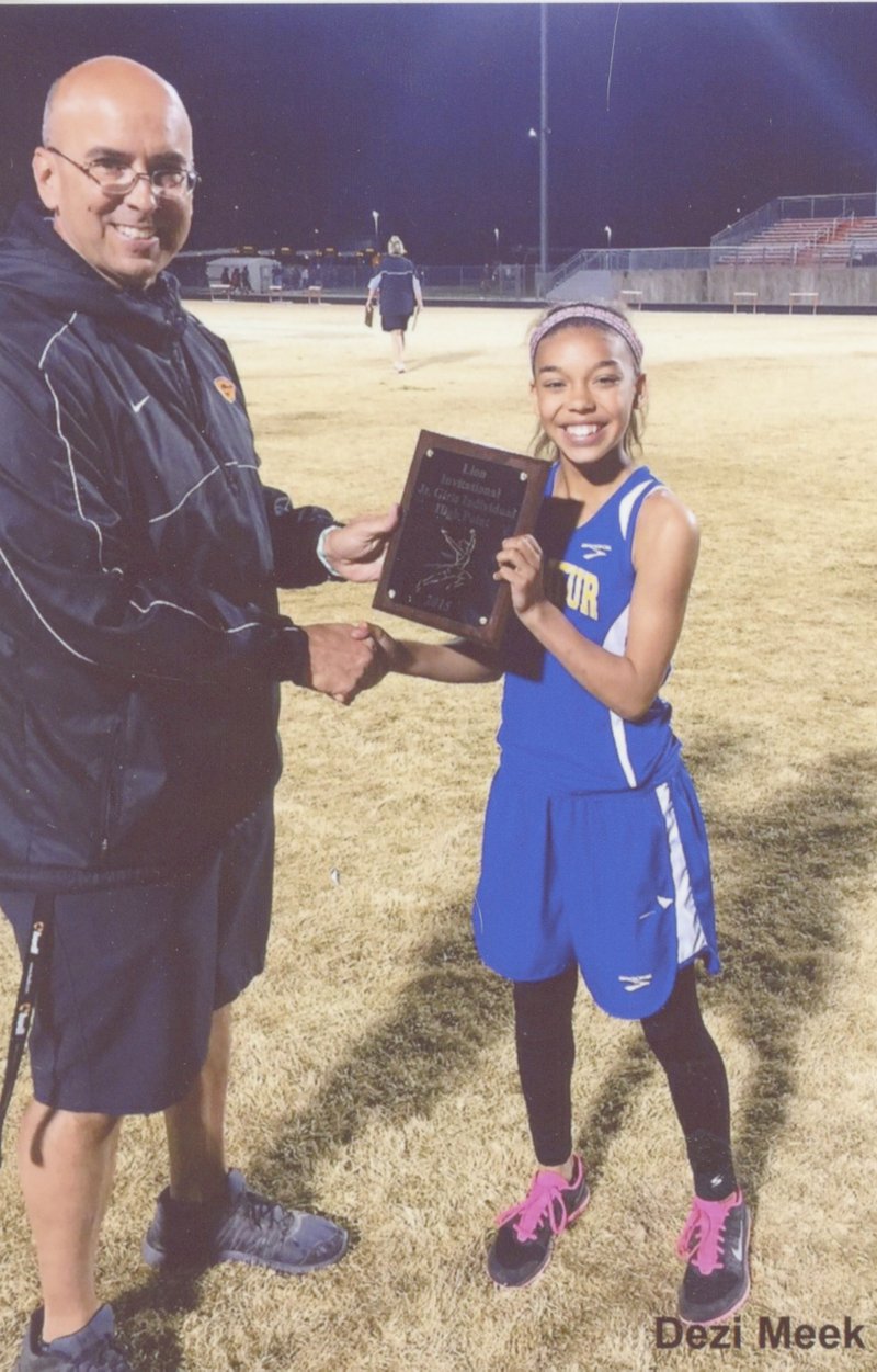 Submitted photo Dezi Meek, daughter of Leonard and Tammy Meek of Decatur, was the individual high point winner in the junior division at the Gravette Lion track meet on March 31. This is Dezi&#8217;s second time to win this award in three track meets. She is an eighth-grader at Decatur Middle School. She is shown receiving her plaque from Gravette middle school coach Dan Childress.