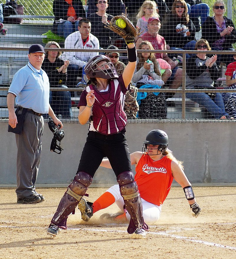Photo by Randy Moll Jaki Chalk slides safely into home for the Lady Lions as the Lady Panther catcher, Morgan Curtis, catches a high throw to home during the April 21 game between Gravette and Siloam Springs at Gravette High School.