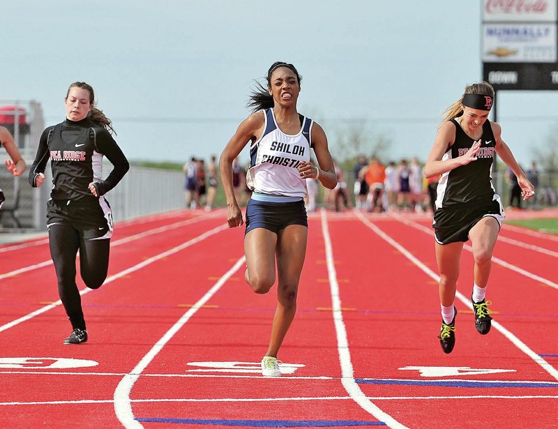 NWA Democrat-Gazette/Michael Woods Catherine Pippins, Shiloh Christian sprinter, edges out Pea Ridge runners Emma Pitts (right) and Ashtyn Mondy to finish first in the girls 100-meter dash during Tuesday at the 4A-1 Conference track meet at Pea Ridge.