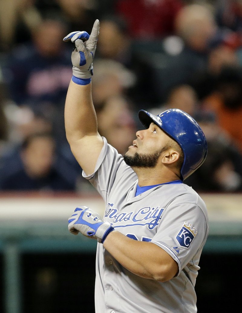 Kansas City Royals Kendrys Morales points up as he runs the bases after hitting a three-run home run off Cleveland Indians relief pitcher Bryan Shaw in the seventh inning of a baseball game, Tuesday, April 28, 2015, in Cleveland. Mike Moustakas and Eric Hosmer scored on the play. 