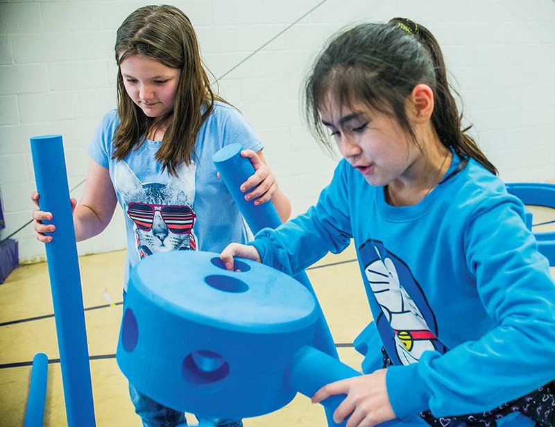 Third-graders Abby Roberts, left, and Jamie Eade work together to make a “rainbow” out of a set of foam blocks at Mayflower Elementary School, where the equipment, called Imagination Playground, was awarded to the school through KaBoom! and funding partner Dr Pepper/Snapple group.