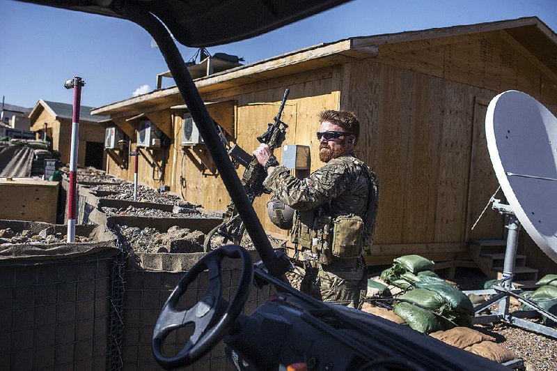 An American special operations soldier prepares for a patrol in June 2014 in Afghanistan’s Parwan province. U.S. forces continue combat operations against the Taliban on land and in the air despite President Barack Obama’s declaration months ago that the war was over. 