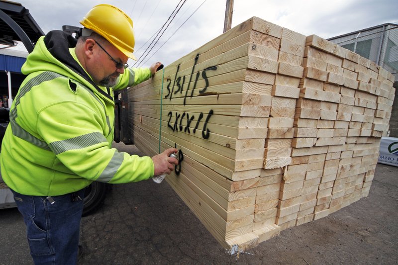 In this March 31, 2015 photo, Roy Livesey marks a pallet of 2x4's at the Allegheny Millwork and Lumberyard in Pittsburgh. The Commerce Department releases first-quarter gross domestic product on Wednesday, April 29, 2015.