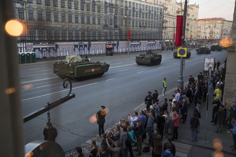 New Russian military vehicles making their way to Red Square are photographed through a cafe window during a rehearsal for the Victory Day military parade which will take place at Moscow's Red Square on May 9 to celebrate 70 years after the victory in WWII, in Moscow, Russia, Wednesday, April 29, 2015.