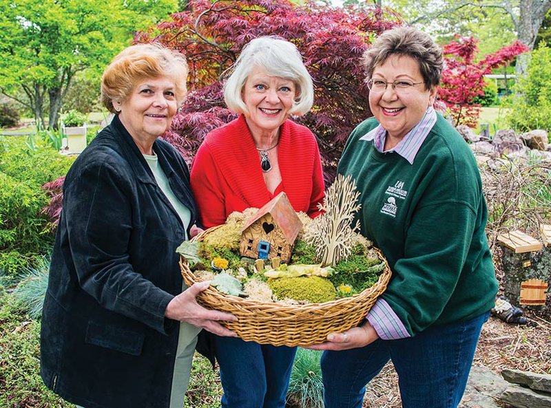 Verna Hicks, from left, Barbara Foster and Cynthia Lacken, members of the Van Buren County Master Gardeners, hold a fairy-garden container that will be for sale during the annual plant sale at Bloomin’ in the Bay on Saturday. The event will be held at Ed Leamon Park in Fairfield Bay and is free and open to the public.