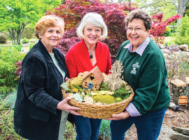 Verna Hicks, from left, Barbara Foster and Cynthia Lacken, members of the Van Buren County Master Gardeners, hold a basket that will be for sale during the group’s annual plant sale during Bloomin’ in the Bay on Saturday at Leamon Park in Fairfield Bay.
