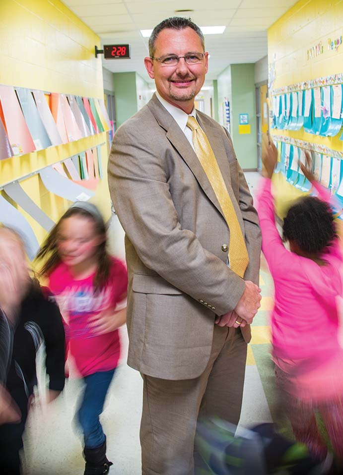 Stacy DeFoor stands amid a flurry of third-graders at Carolyn Lewis Elementary School in Conway. He helped open the school three years ago and has now been hired to become the principal of Florence Mattison Elementary School in Conway for the upcoming school year. After getting a degree in education, DeFoor spent many years as a manager for McDonald’s, but eight years ago, he decided to follow his original dream to go into education.