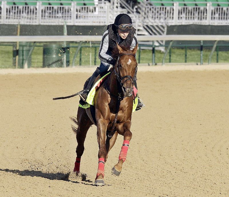 Exercise rider Laura Moquett, wife of trainer Ron Moquett, gallops Kentucky Derby hopeful Far Right during a recent workout at Churchill Downs in Louisville, Ky.