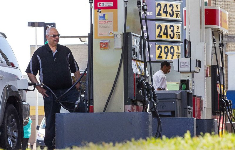 Motorists gas up Friday at the Shell station at Eighth Street and Broadway in Little Rock. Gas prices in Arkansas have risen 17 cents in the past month and were at an average $2.38 a gallon Friday. 