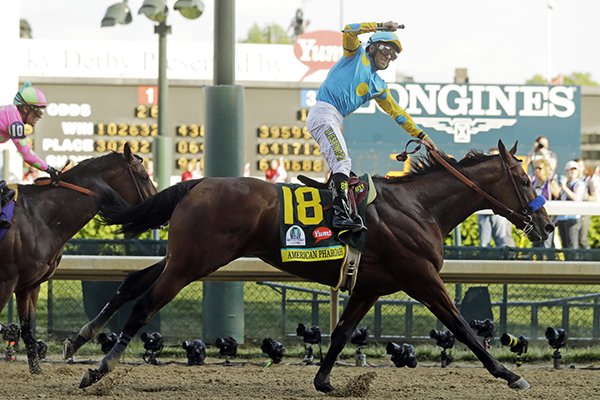 Victor Espinoza rides American Pharoah to victory in the 141st running of the Kentucky Derby horse race at Churchill Downs Saturday, May 2, 2015, in Louisville, Ky. (AP Photo/Morry Gash)