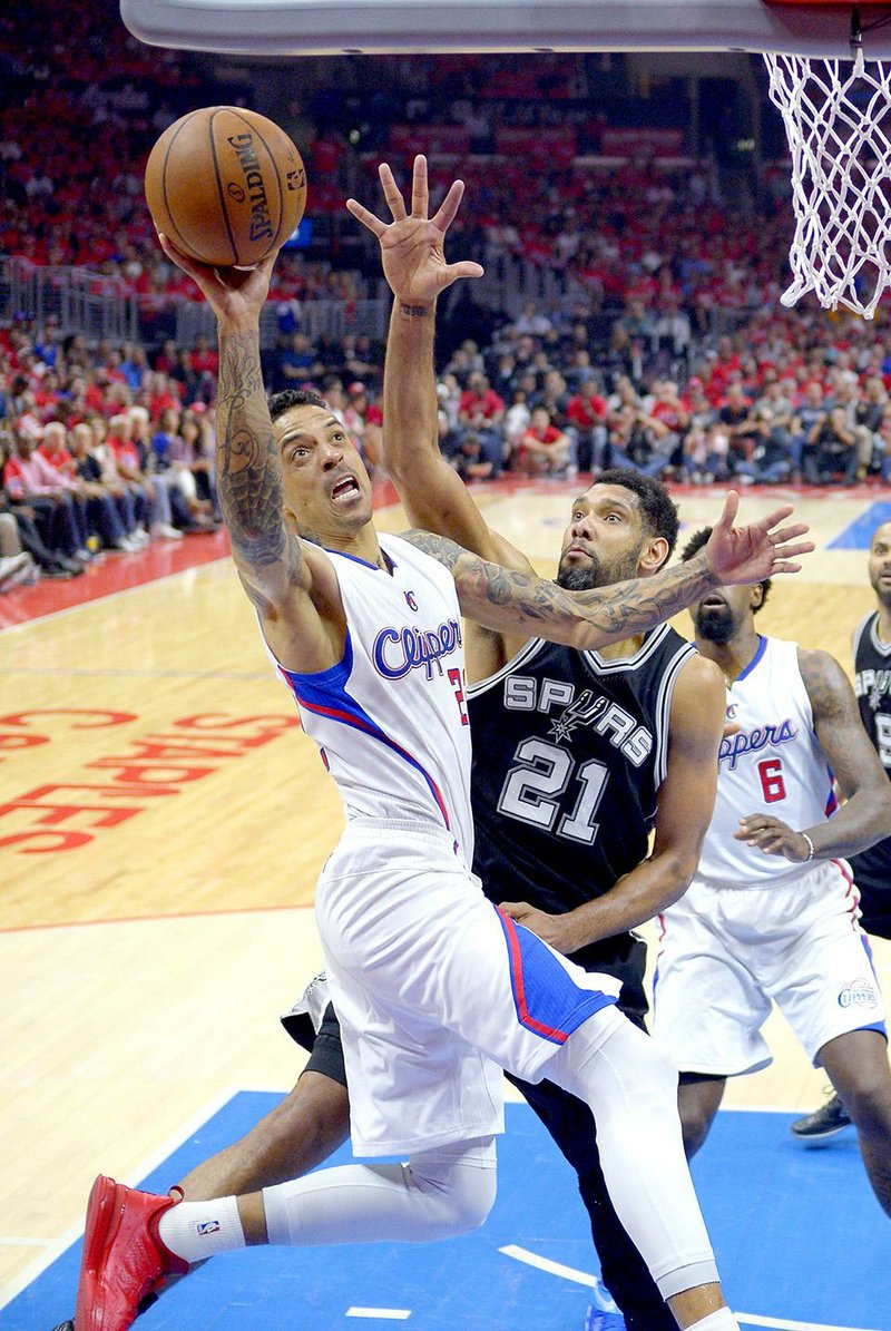 Los Angeles Clippers forward Matt Barnes, left, shoots as San Antonio Spurs forward Tim Duncan defends during the first half of Game 7 in a first-round NBA basketball playoff series, Saturday, May 2, 2015, in Los Angeles. (AP Photo/Mark J. Terrill)