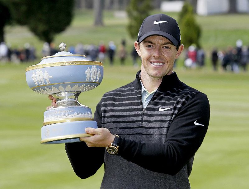Rory McIlroy, of Northern Ireland, poses with his trophy on the 16th green of TPC Harding Park after winning the Match Play Championship golf tournament Sunday, May 3, 2015, in San Francisco. (AP Photo/Eric Risberg)