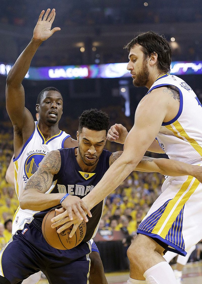Memphis Grizzlies guard Courtney Lee, center, dribbles against Golden State Warriors forward Harrison Barnes, left, and center Andrew Bogut during the first half of Game 1 in a second-round NBA playoff basketball series in Oakland, Calif., Sunday, May 3, 2015. (AP Photo/Marcio Jose Sanchez)