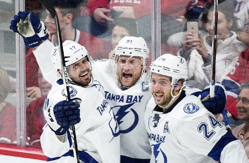 Tampa Bay Lightning's Steven Stamkos, center, celebrates with teammates Alex Killorn (17) and Ryan Callahan after scoring against the Montreal Canadiens during second period of Game 2 NHL second round playoff hockey action in Montreal, Sunday, May 3, 2015. (Graham Hughes/The Canadian Press via AP)   MANDATORY CREDIT
