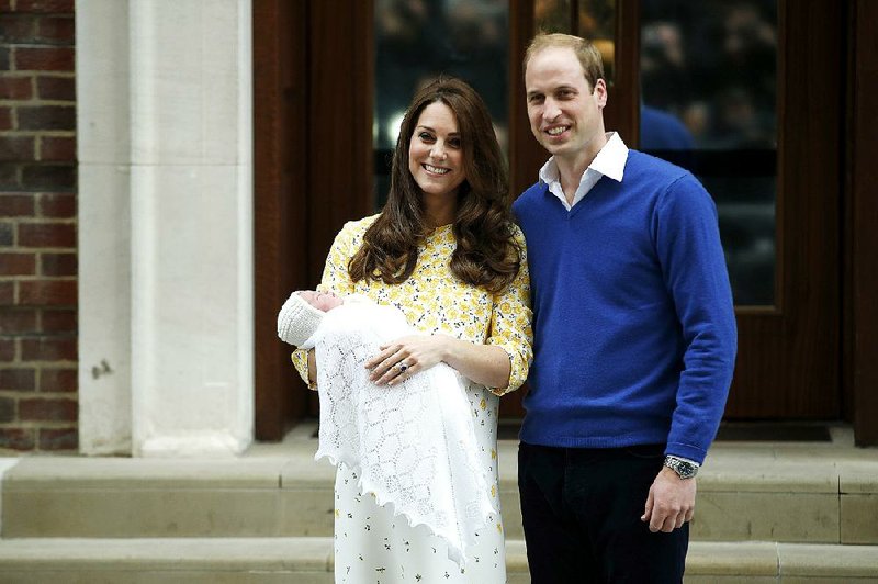 Britain's Prince William, right, and Kate, Duchess of Cambridge, hold their newborn daughter as they pose for the media outside the St. Mary's Hospital's exclusive Lindo Wing, London, Saturday, May 2, 2015. The Duchess gave birth to the Princess on Saturday morning. (AP Photo/Alastair Grant)