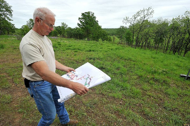 NWA Democrat-Gazette/Michael Woods --04/25/2015--w@NWAMICHAELW... Gary Base with Explosive Ordnance Technologies Inc. shows a map of the areas his teams are working to clear old ammunition and explosive materials at Fort Chaffee.  The old firing range will be updated to become an infantry platform battle course with updated technology to help train troops for a variety of possible war time scenarios .