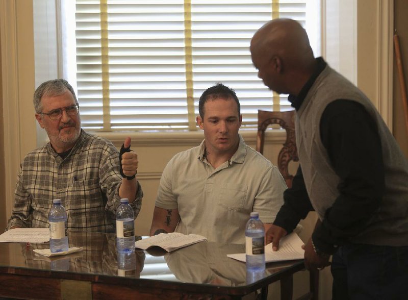 Arkansas Democrat-Gazette/STATON BREIDENTHAL --4/25/15-- Jake Tidmore (left) gives thumbs up to classmate Roderick Billings (right) after Billings read his story during an Arkansas Literary Festival event at the MacArthur Museum of Arkansas Military History. Tidmore, Billings and Justin Fisher (middle) are all veterans enrolled in a Creative Writing for Veterans class at Pulaski Tech. 