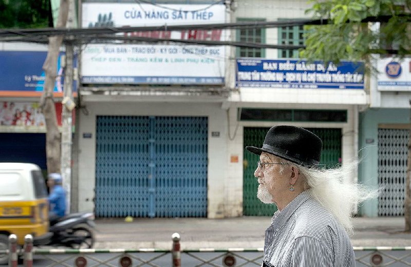 Vietnam veteran Jim Reischl, photographed in March across from where he and a Vietnamese girlfriend shared a small apartment decades ago in Saigon, now Ho Chi Minh City, Vietnam. Illustrates VIETNAM-VETERANS (category i), by Annie Gowen © 2015, The Washington Post. Moved Tuesday, April 28, 2015. (MUST CREDIT: Washington Post photo by Linda Davidson)