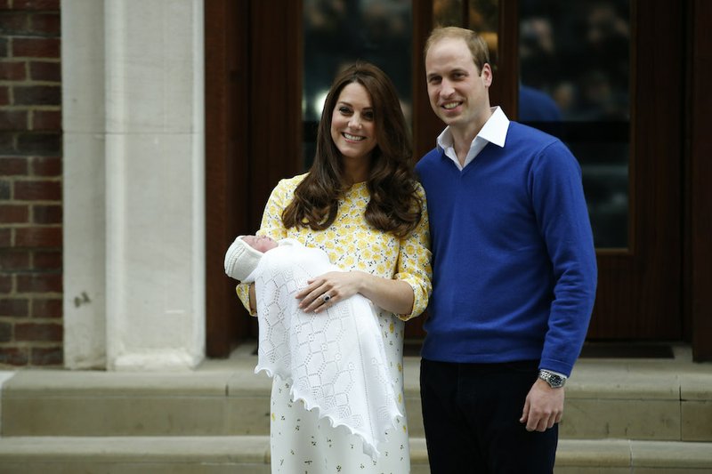 Britain's Prince William, right, and Kate, Duchess of Cambridge, hold their newborn daughter as they pose for the media outside the St. Mary's Hospital's exclusive Lindo Wing in London on Saturday, May 2, 2015. The Duchess gave birth to the Princess on Saturday morning. 