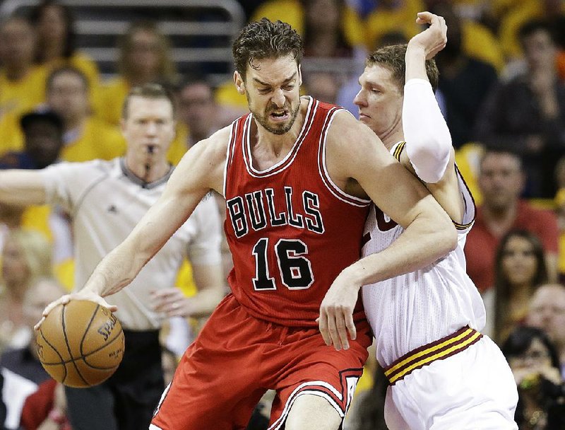 Chicago Bulls forward Pau Gasol (16) drives against Cleveland Cavaliers center Timofey Mozgov during the first half of Game 1 in a second-round NBA basketball playoff series Monday, May 4, 2015, in Cleveland. (AP Photo/Tony Dejak)