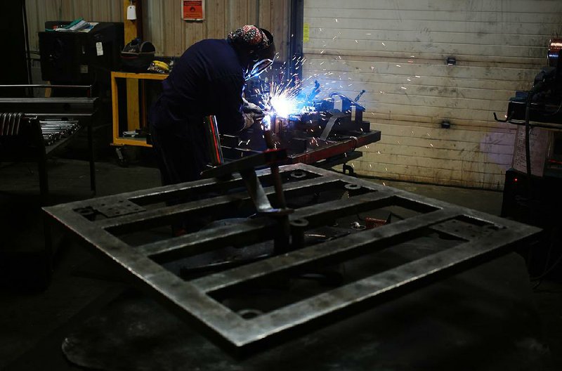 A welder works on a piece of Hammer Strength weightlifting equipment during production at the Life Fitness manufacturing facility in Falmouth, Kentucky, U.S., on Thursday, April 9, 2015. The U.S. Census Bureau is scheduled to release durable goods figures on April 24. Photographer: Luke Sharrett/Bloomberg