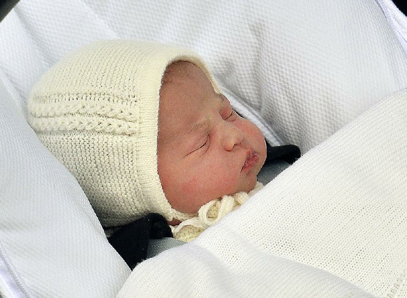 The newborn baby princess, born to parents Kate Duchess of Cambridge and Prince William, is carried in a car seat by her father from The Lindo Wing of St. Mary's Hospital, in London, Saturday, May 2, 2015.  Kate, the Duchess of Cambridge, gave birth to their second child, a baby girl on Saturday morning. The name of the new born baby princess is not yet announced. (John Stillwell/Pool via AP)