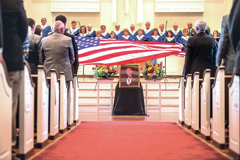 NWA Democrat-Gazette/ANTHONY REYES &#8226; @NWATONYR An American flag is folded Monday at the end of a memorial service for John Paul Hammerschmidt at the First Presbyterian Church in Harrison. Friends and family gathered for the event including Gov. Asa Hutchinson, Sen. John Boozman, R-Rogers, and 3rd District Rep. Steve Womack, R-Rogers, among others.