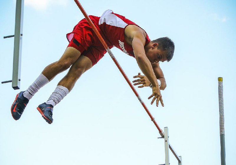 Jonesboro Westside pole vaulter Michael Carr goes over the crossbar to set a Class 4A record of 16 feet in the state track and field meet Tuesday at Heber Springs High School.