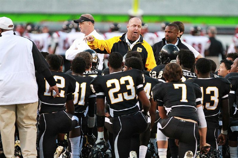 Starkville (Miss.) football coach Jamie Mitchell (center), who won a state title in five years with the Yellow Jackets, is being recommended to be the new coach at North Little Rock this week.
