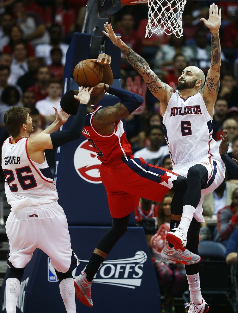 Atlanta Hawks forward Pero Antic (6) stops Washington Wizards guard Bradley Beal during the Hawks’ 106-90 victory in Game 2 of their NBA Eastern Conference semifinals series Tuesday night in Atlanta. 