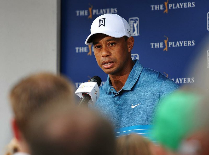 Tiger Woods talks with the media after a practice round for The Players Championship golf tournament in Ponte Vedra Beach, Fla., Tuesday, May 5, 2015.   