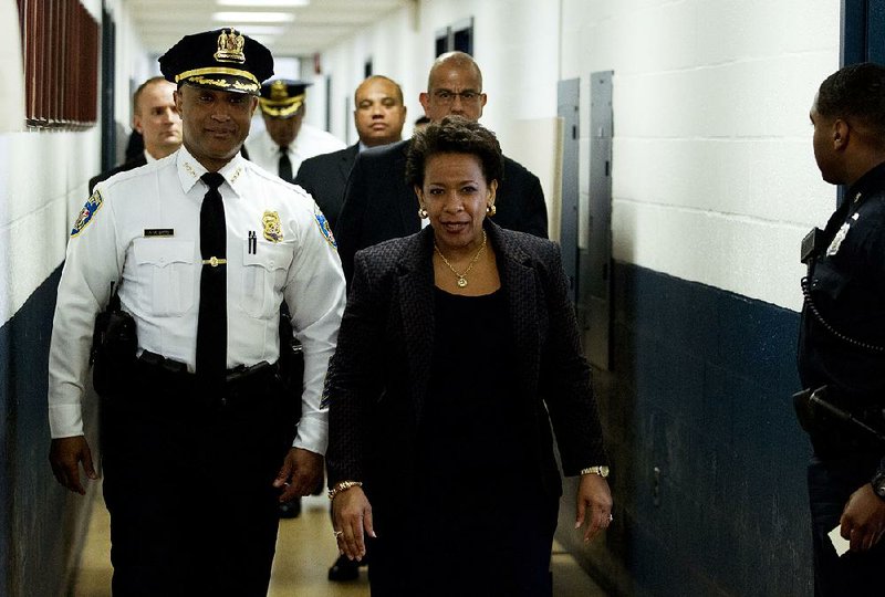 Attorney General Loretta Lynch, accompanied by Baltimore Police Commissioner Anthony Batts, visits a police station Tuesday in Baltimore. She also met with family members of Freddie Gray, whose death while in police custody touched off violent protests. 