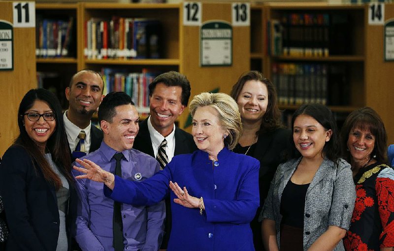 Hillary Rodham Clinton poses for photos Tuesday at Rancho High School in Las Vegas, where she spoke out for “full and equal citizenship” as a central part of immigration changes.