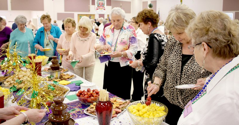 Submitted Women attending St. Bernard&#8217;s Women&#8217;s Club annual Spring Luncheon/Card Party enjoy the chocolate fountain table.