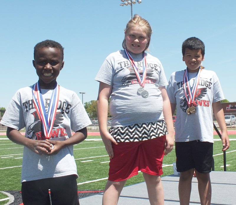 These children won their event in the 8- to 12-year-old category and were pleased to show off their medals.