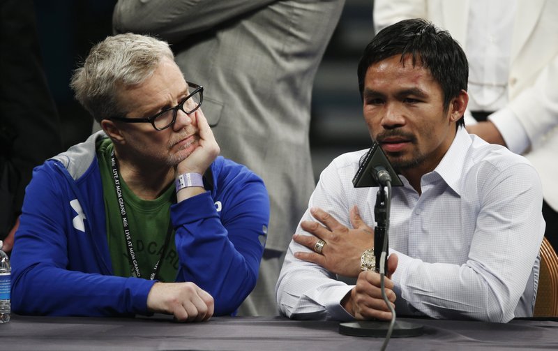  In this May 2, 2015 photo, trainer Freddie Roach, left, listens as Manny Pacquiao answers questions during a press conference following his welterweight title fight against Floyd Mayweather Jr. in Las Vegas. Pacquiao could face disciplinary action from Nevada boxing officials for failing to disclose a shoulder injury before the fight. Nevada Athletic Commission Chairman Francisco Aguilar said that the state attorney generals office will look at why Pacquiao checked no a day before the fight on a commission questionnaire asking if he had a shoulder injury.