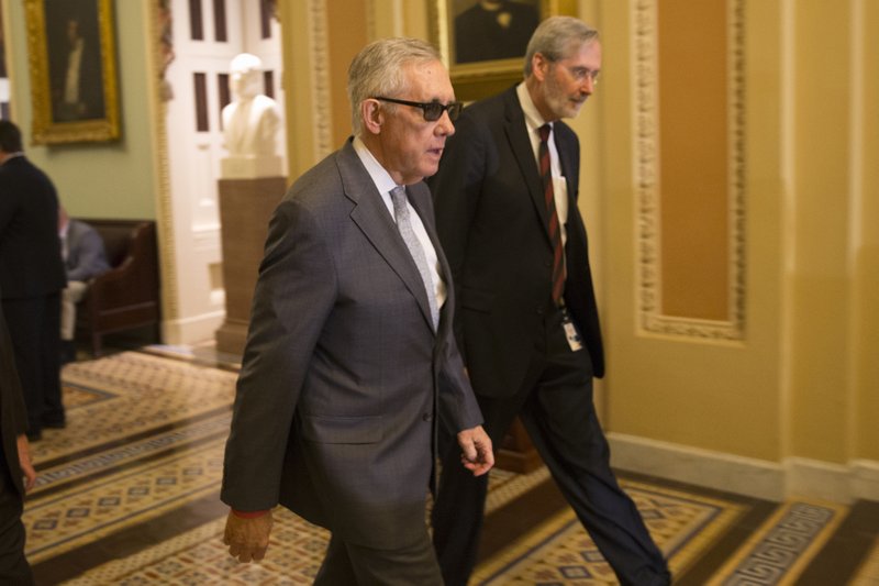 Senate Minority Leader Sen. Harry Reid of Nev. walks to a news conference on Capitol Hill in Washington, Tuesday, May 5, 2015, after a policy luncheon. 