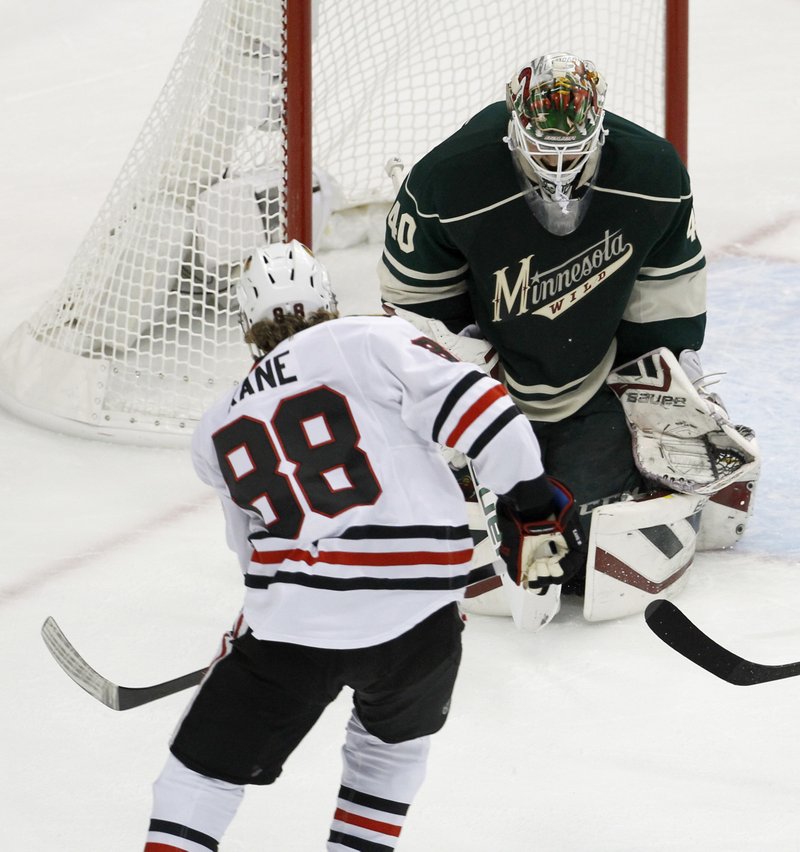 Chicago Blackhawks right wing Patrick Kane (88) scores on Minnesota Wild goalie Devan Dubnyk (40) during the first period of Game 3 in the second round of the NHL Stanley Cup hockey playoffs in St. Paul, Minn., Tuesday, May 5, 2015.