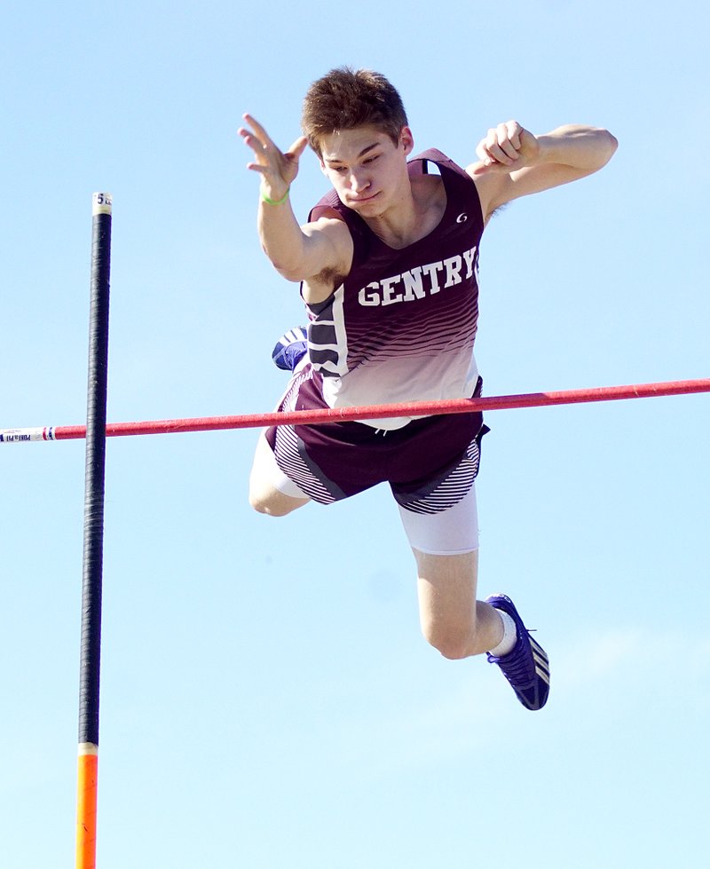 File Photo — Gentry's Bryan Harris clears the bar during pole-vaulting competition in Gentry.