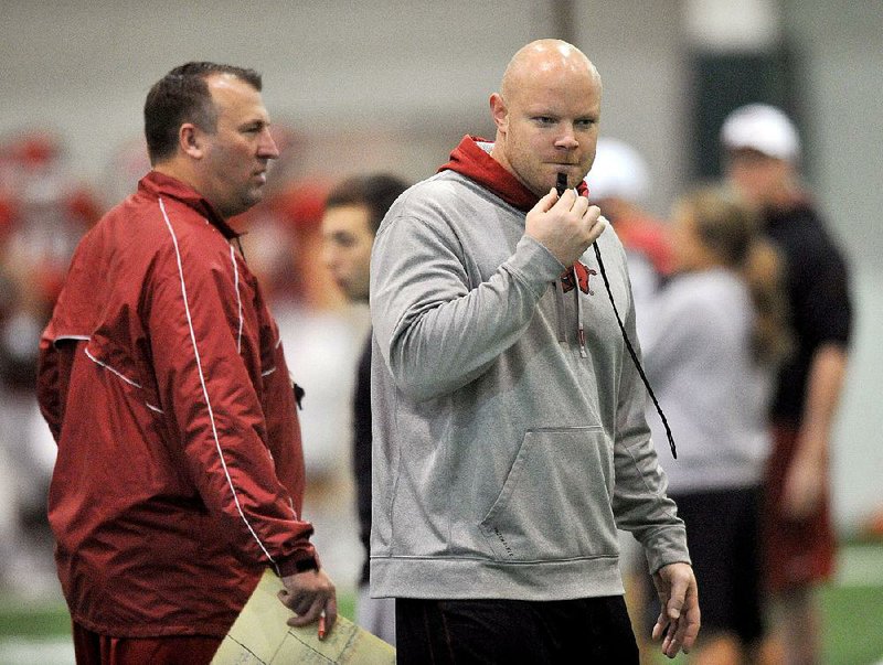 University of Arkansas Assistant Head Strength and Conditioning Coach Ben Herbert works with the Razorbacks during practice in this file  photo.