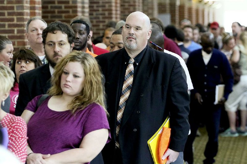 People wait in line last month at a job fair held at The Colonnade in Ringgold, Ga. Payroll processor ADP said businesses added 169,000 jobs in April, a decline from 175,000 in March. 