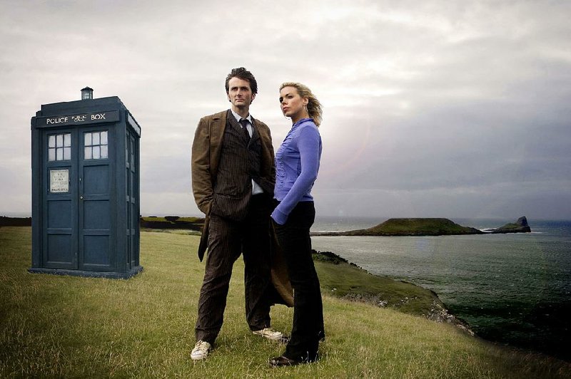 David Tennant stars as The Doctor and Billie Piper as Rose in Doctor Who, Series 2. Behind them is the series’ famous TARDIS.
