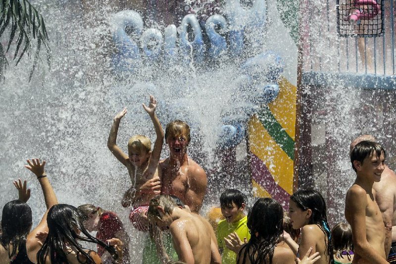 A thousand gallons of water pour every 10 minutes from the Big Bucket in the Splash Island play area of Magic Springs’ Crystal Falls water park. 