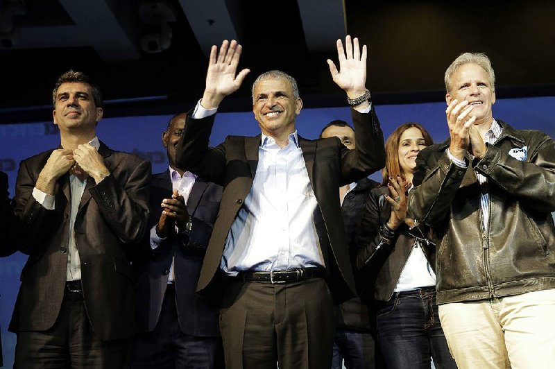 Moshe Kahlon, Kulanu party leader, greets his supporters  in the city of Tel Aviv, Wednesday, March 18, 2015. 