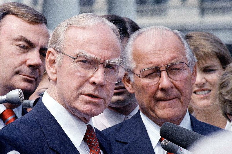 Jim Wright of Texas (left), the House speaker, talks to reporters with House Minority Leader Robert Michel outside the White House on Aug. 5, 1987. Wright, who died Wednesday at 92, served in the House from 1955 until his resignation in 1989. 