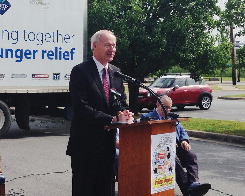 Gov. Asa Hutchinson encourages the public to participate in the 23rd annual Stamp Out Hunger Food Drive at the U.S. Post Office in Little Rock on Thursday, May 7, 2015. 