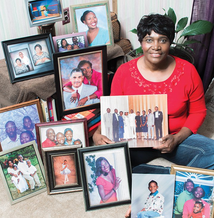 Mae Young sits in her living room, where she is surrounded by photos of her children and grandchildren. Young has seven children and will spend time with some of them, as well as her grandchildren, today for Mother’s Day.